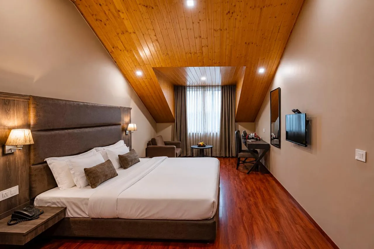 Attic bedroom with a pine-panelled sloping ceiling