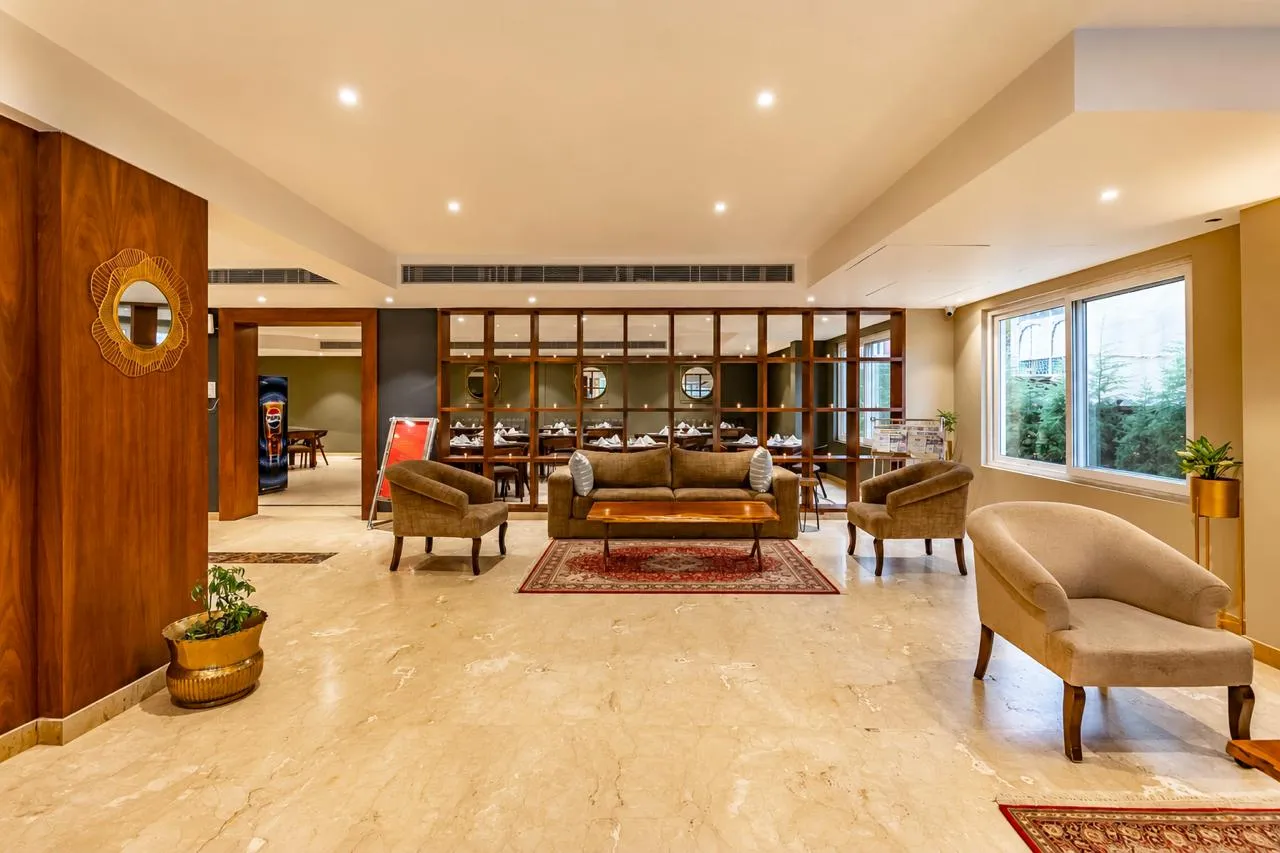 Bright hotel lobby with marble floors and lounge seating