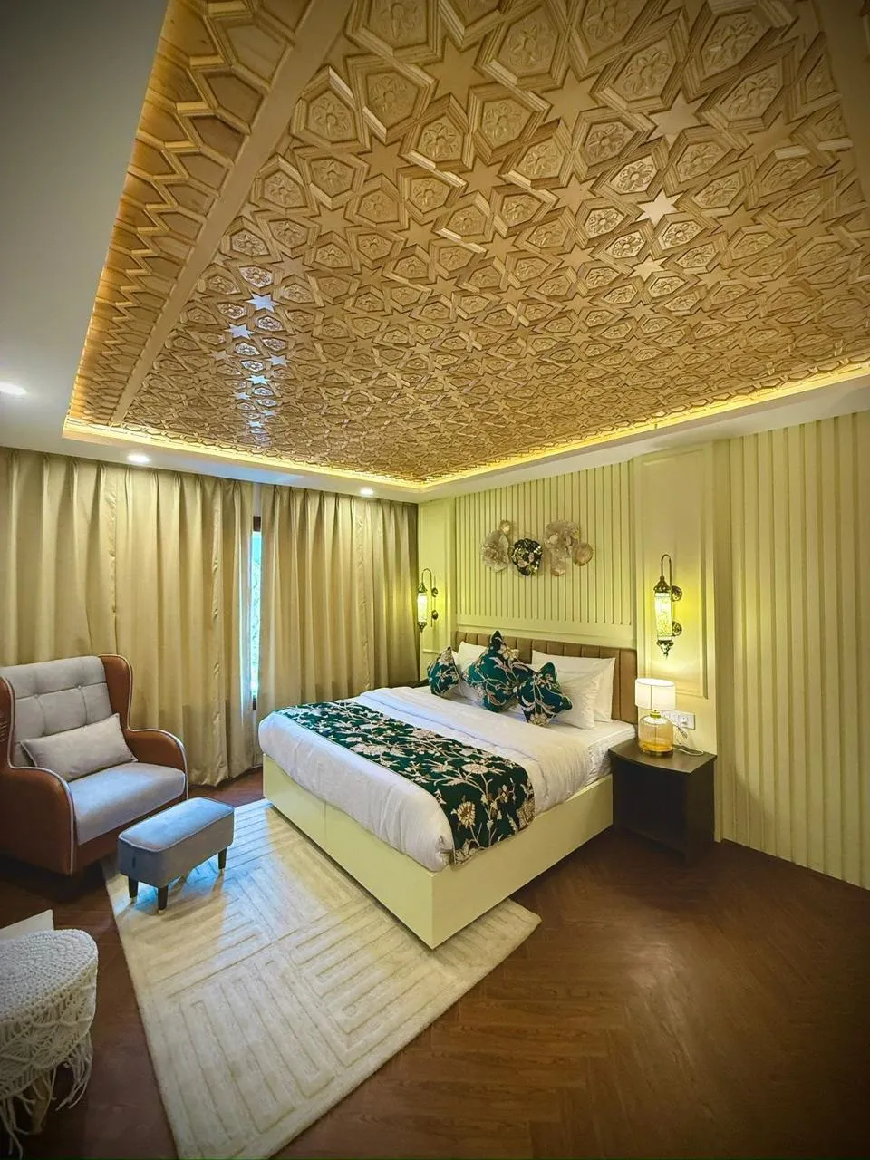 Suite with a hand-carved wooden ceiling and green embroidered bedding
